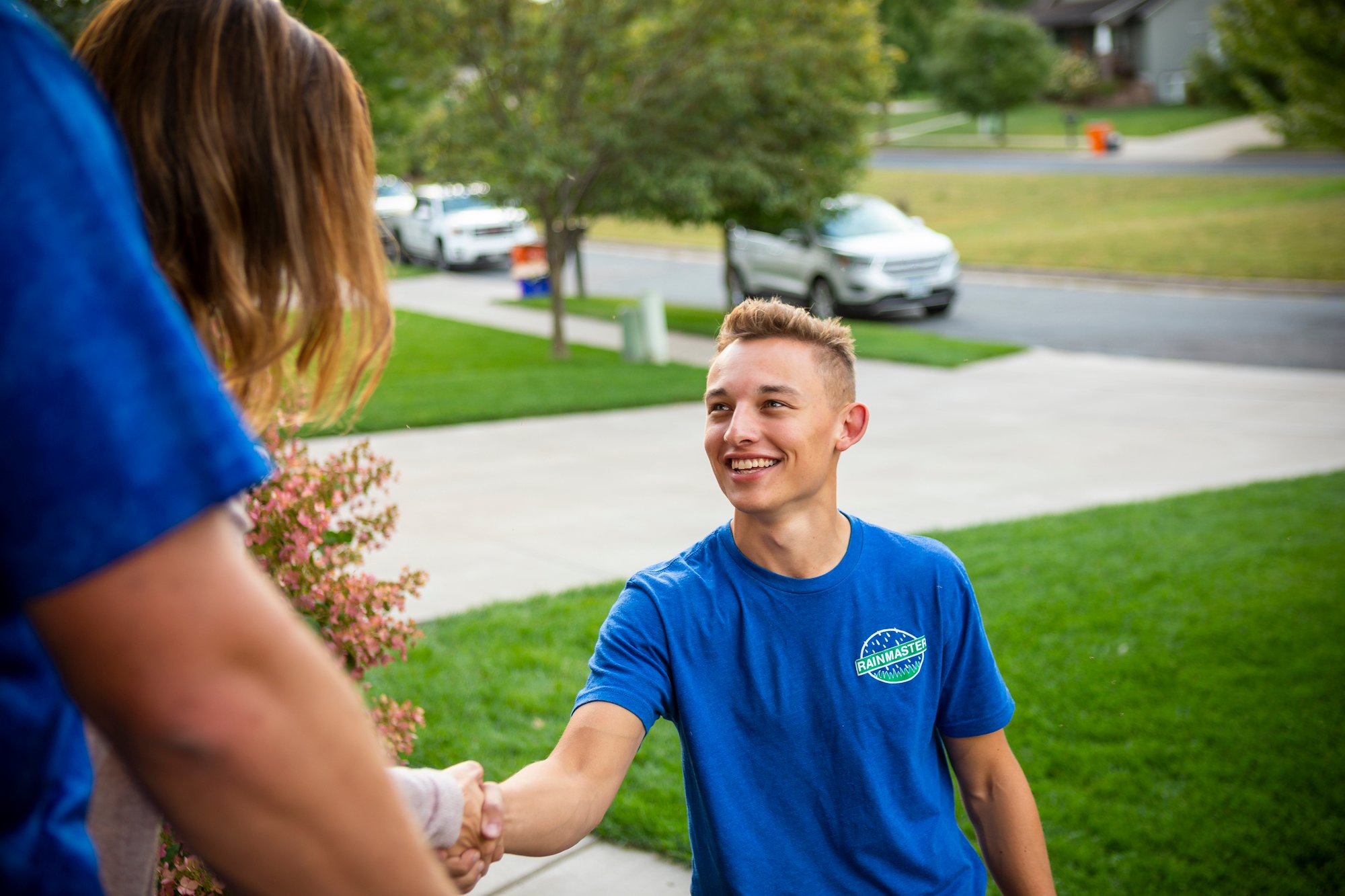 lawn care professional meeting with homeowners