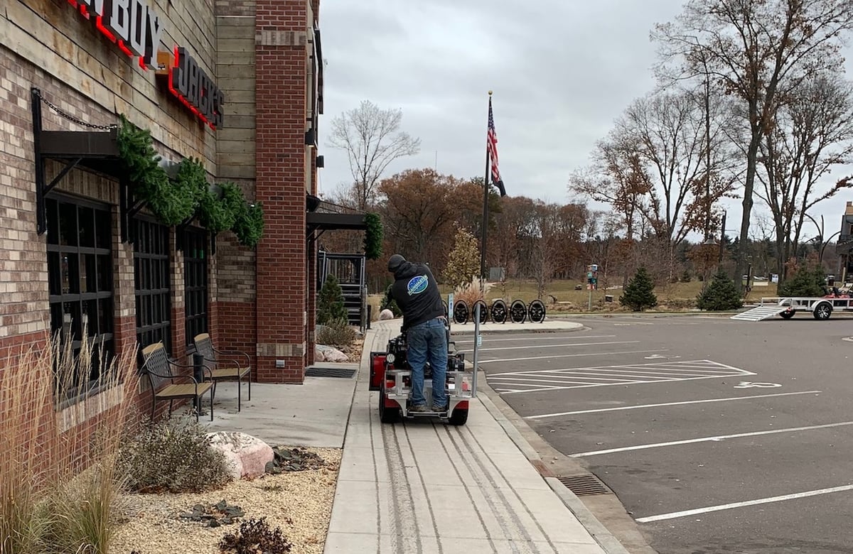 liquid brine being spread on sidewalks