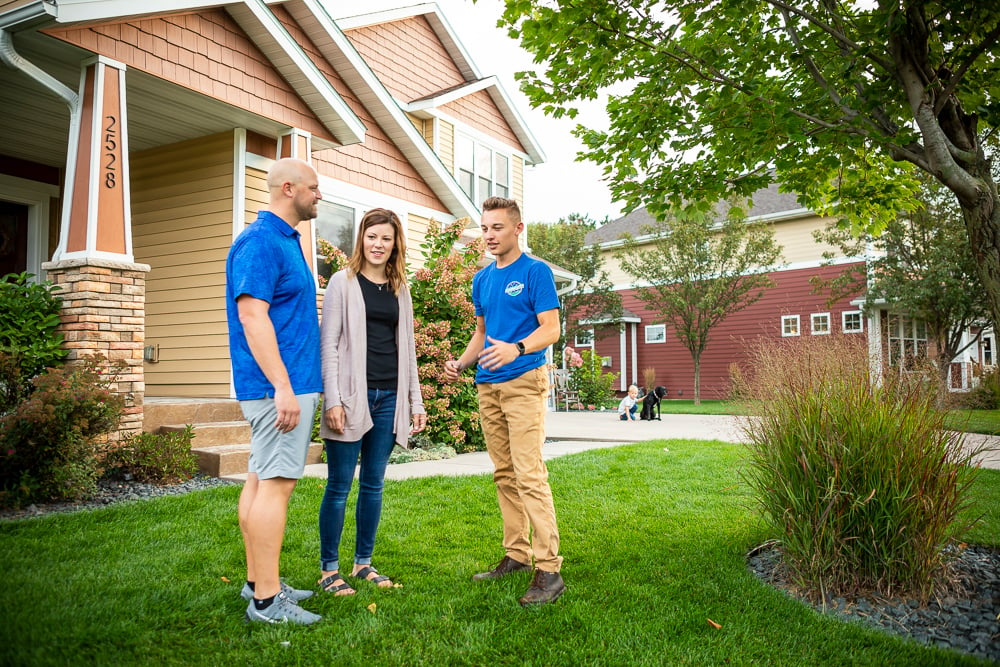 RainMaster lawn technician with customers