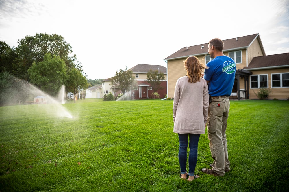 irrigation technician shows client how to operate irrigation system