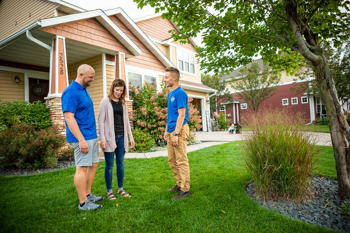 RainMaster lawn care technician talking to customers