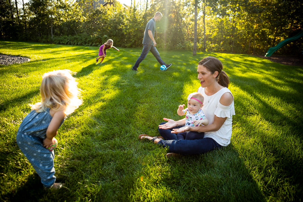 family plays on healthy lawn