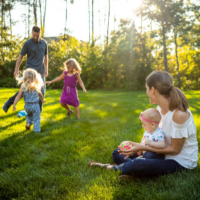 family playing on a nice lawn in summer