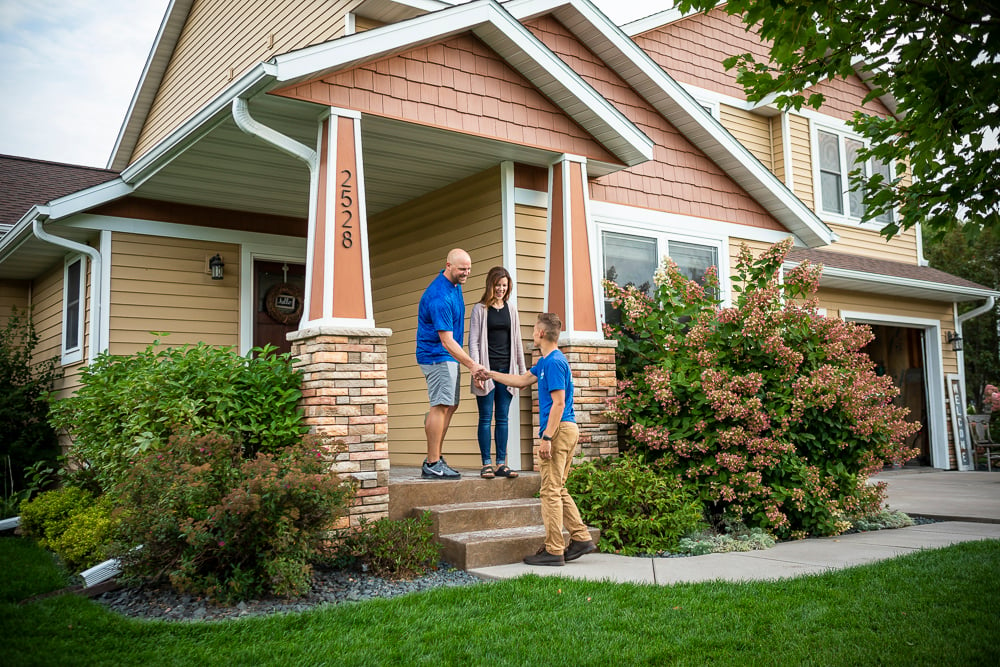 lawn care specialist shakes hands with clients