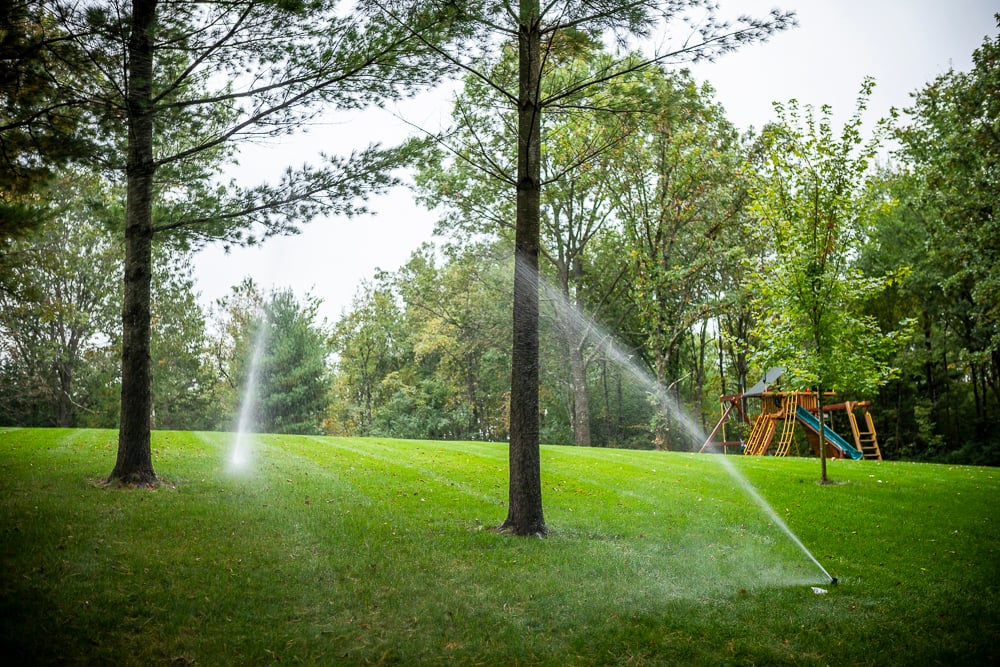 sprinkler system waters lawn 