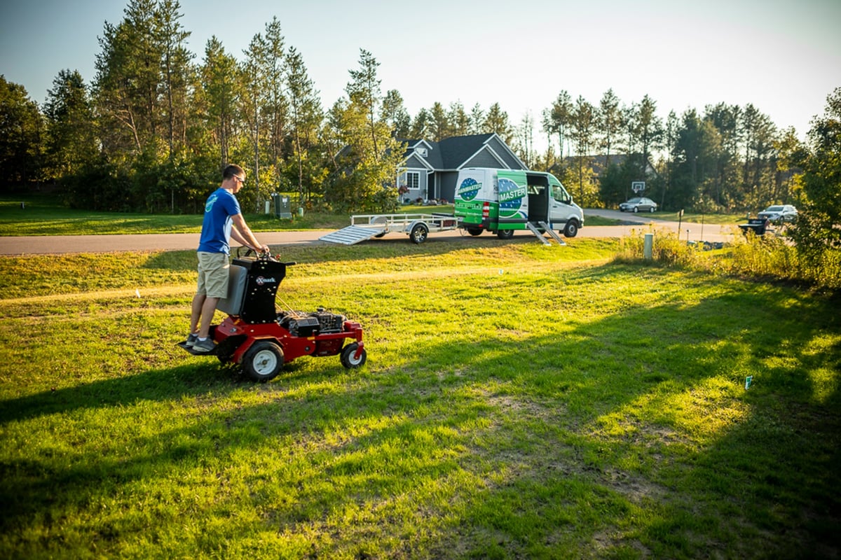 landscape maintenance team aerates lawn