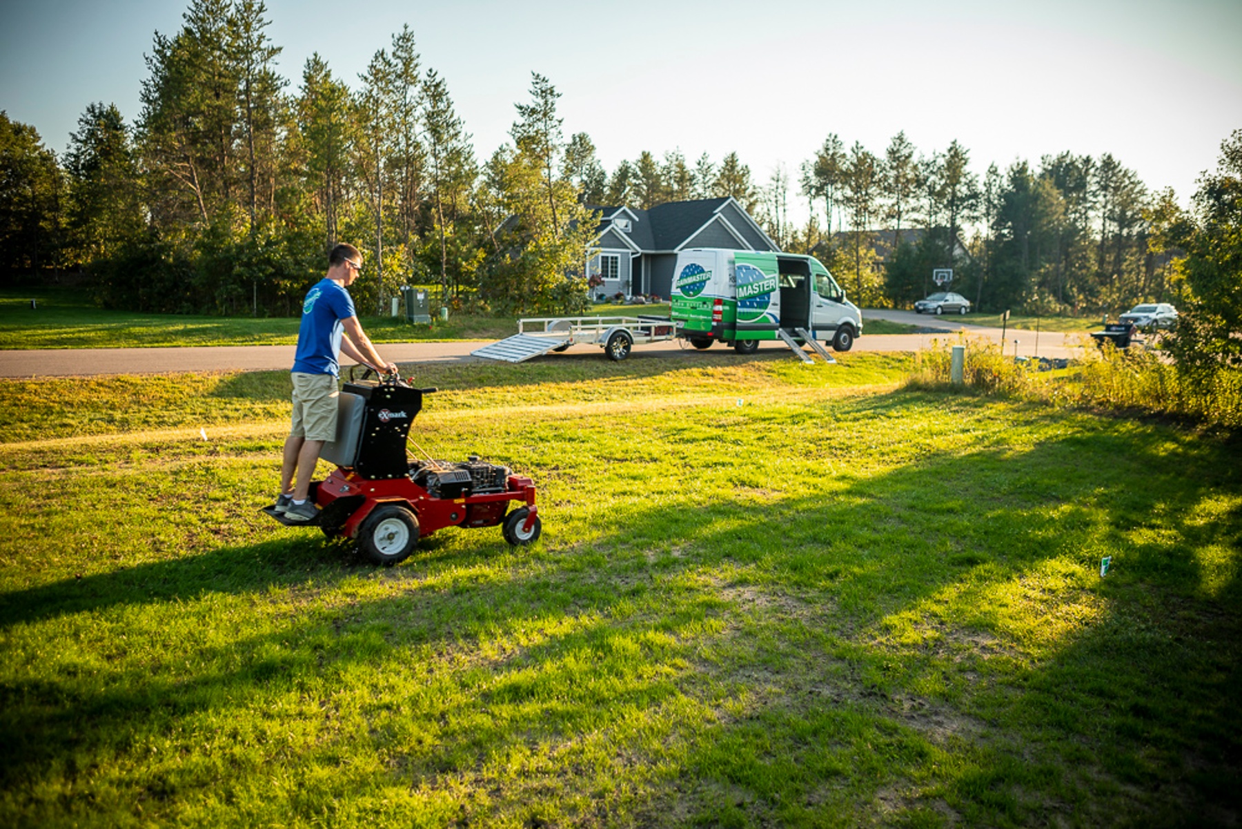 Professional lawn care team aerating a lawn