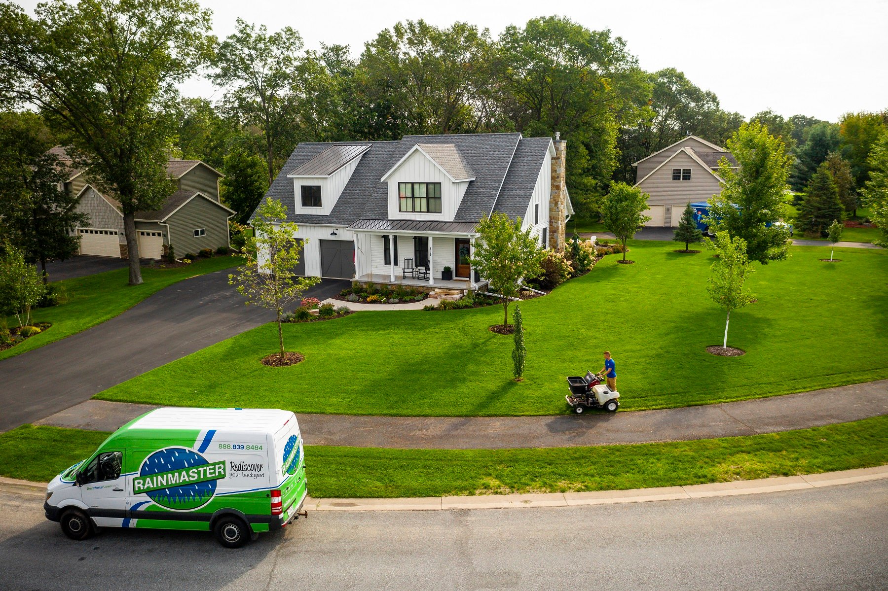 aerial photo of healthy lawn being fertilized