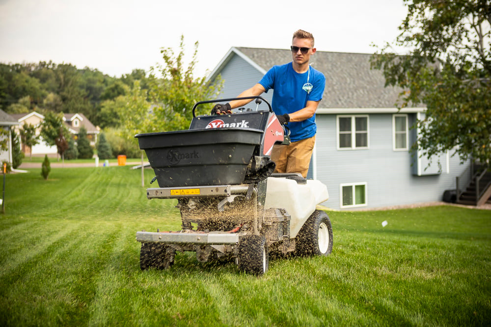 lawn team overseeding lawn after aeration