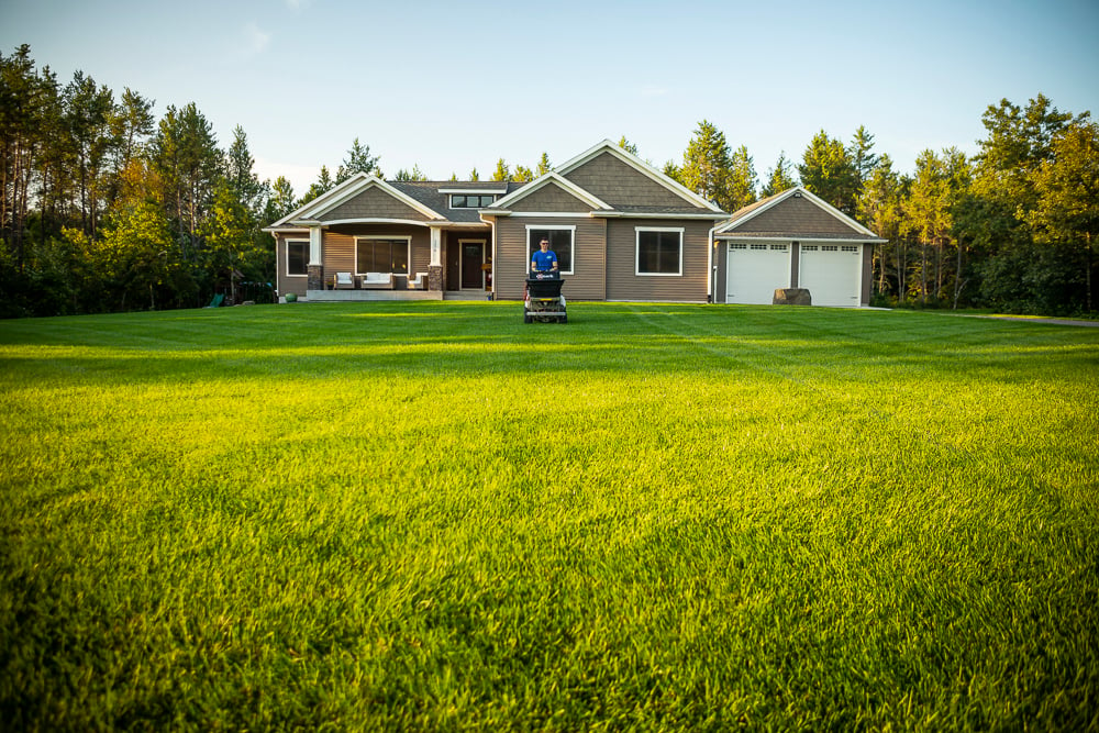 lawn technician applying grub control