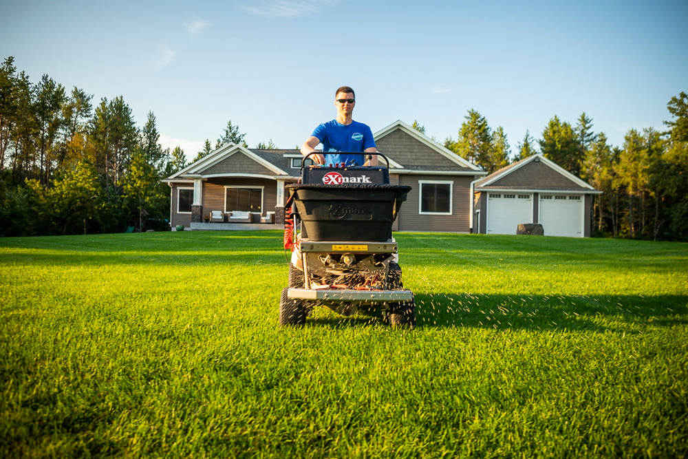 lawn technician applying fertilizer