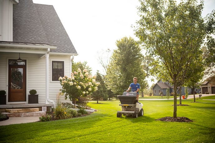 lawn care company technician caring for lawn in Eau Claire, WI