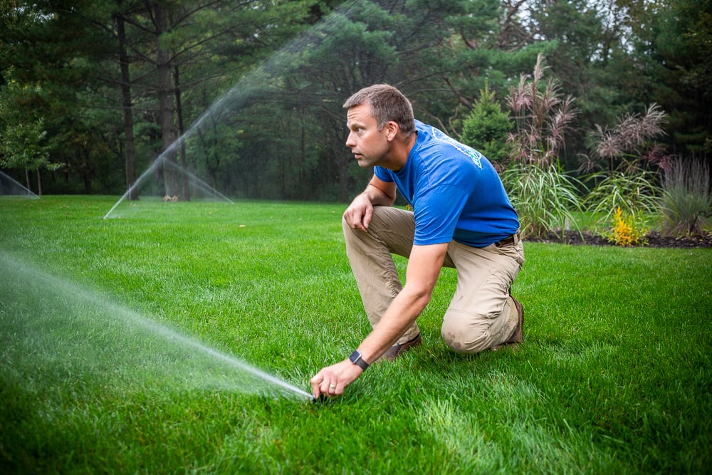 irrigation team adjusts sprinkler heads