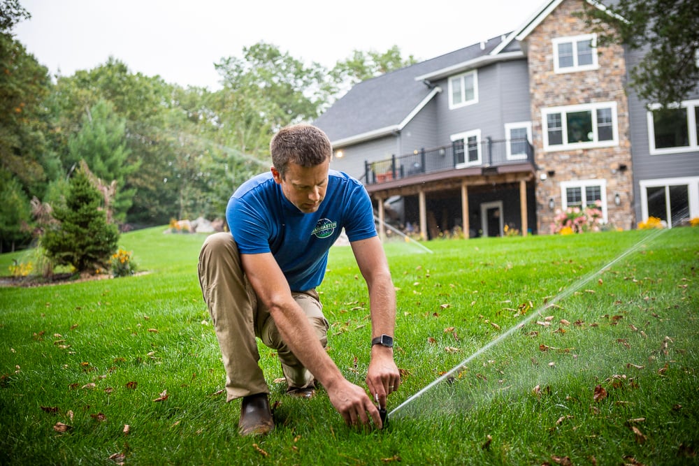 lawn team adjusting irrigation heads