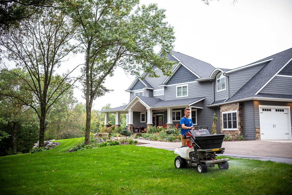 Lawn care team applying liquid weed control