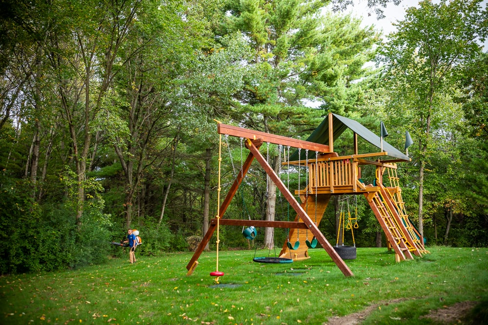 pest control team sprays near swing set