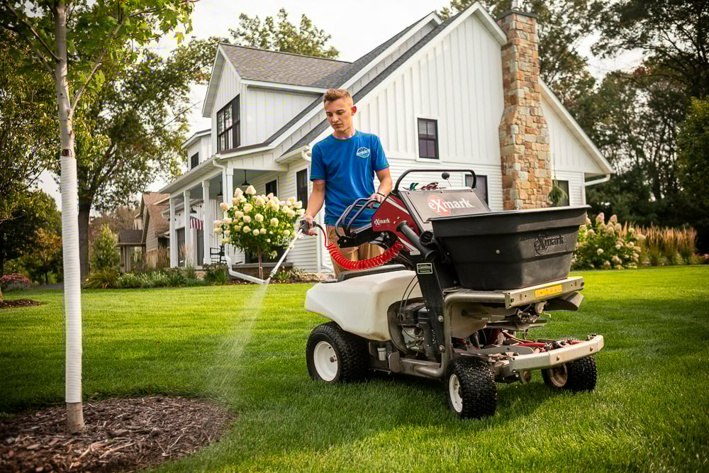 lawn care technician spraying