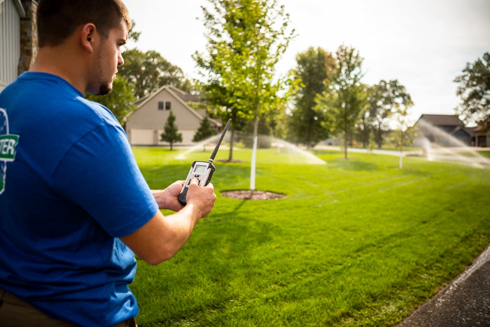 Man using smart irrigation system controller