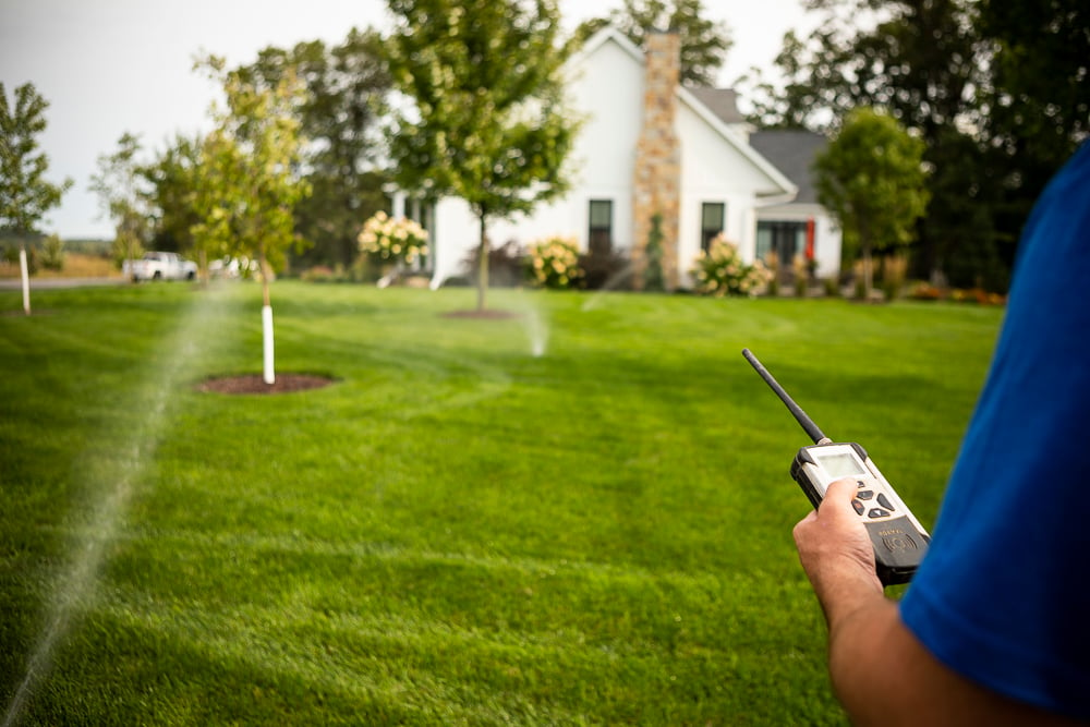 Irrigation team inspecting sprinkler system