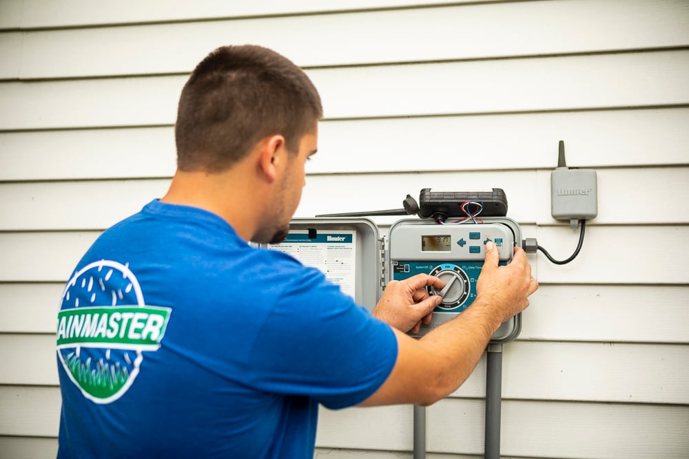 irrigation technician adjusts controller