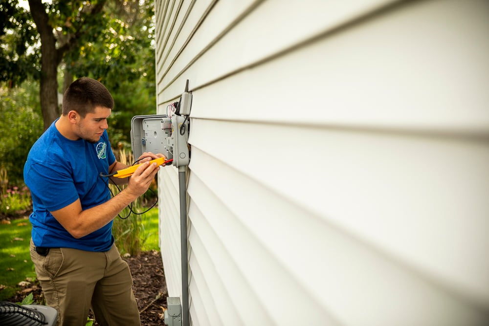 Irrigation technician adjusting controls