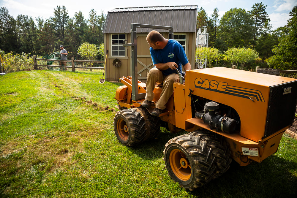 machine digs ditch for sprinkler system