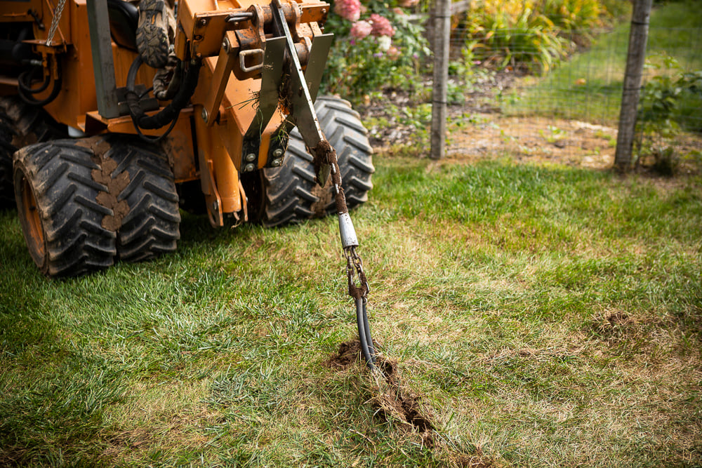a lawn trenching machine excavating for a lawn sprinkler installation