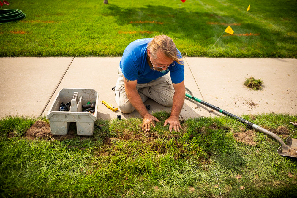 irrigation team repairs broken sprinkler system