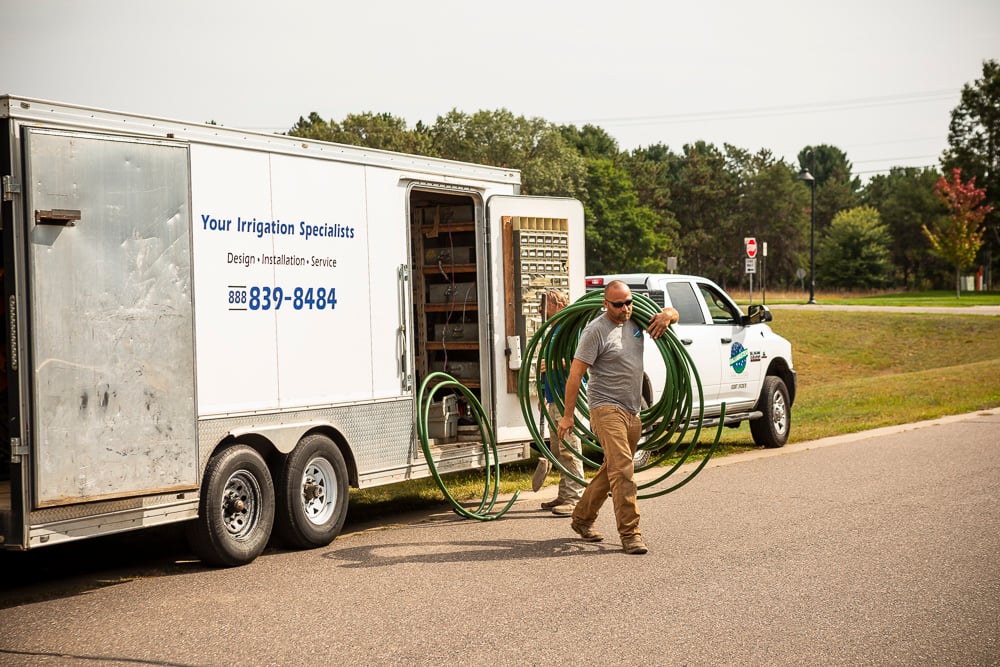 irrigation technicians and trailer with equipment