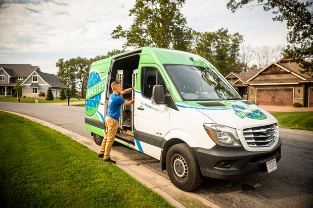 lawn care technician unloading a crew truck