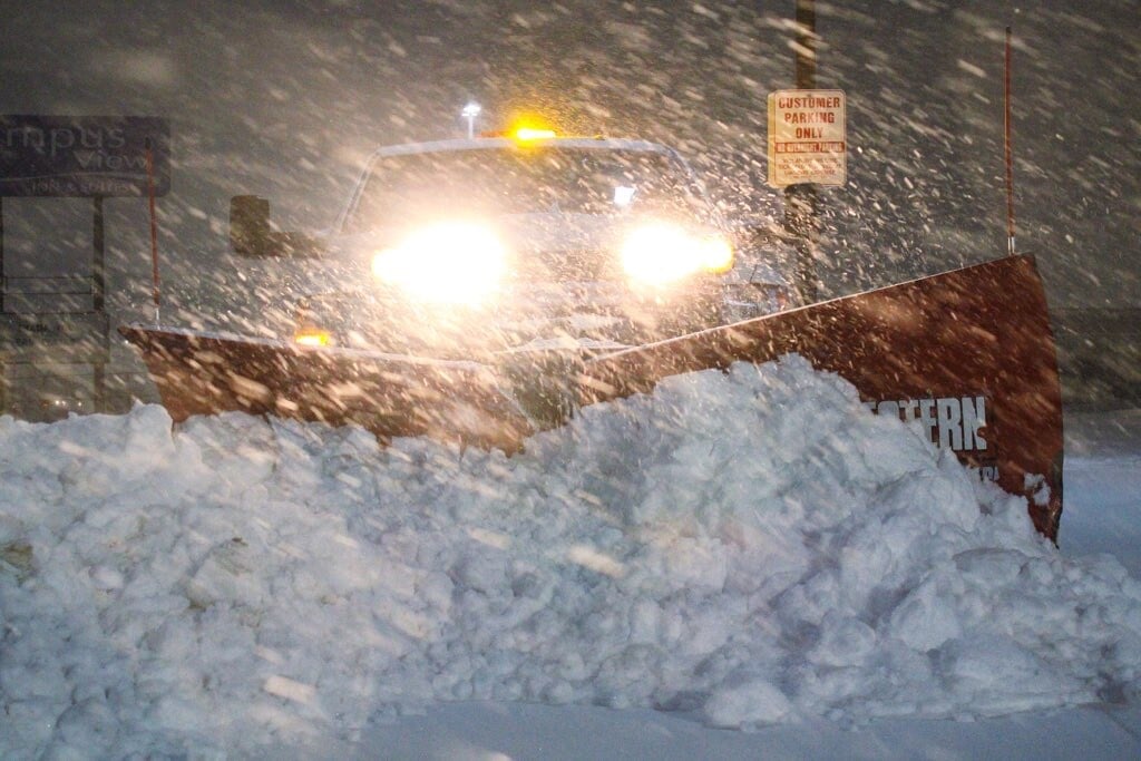 commercial snow removal truck plowing heavy snow