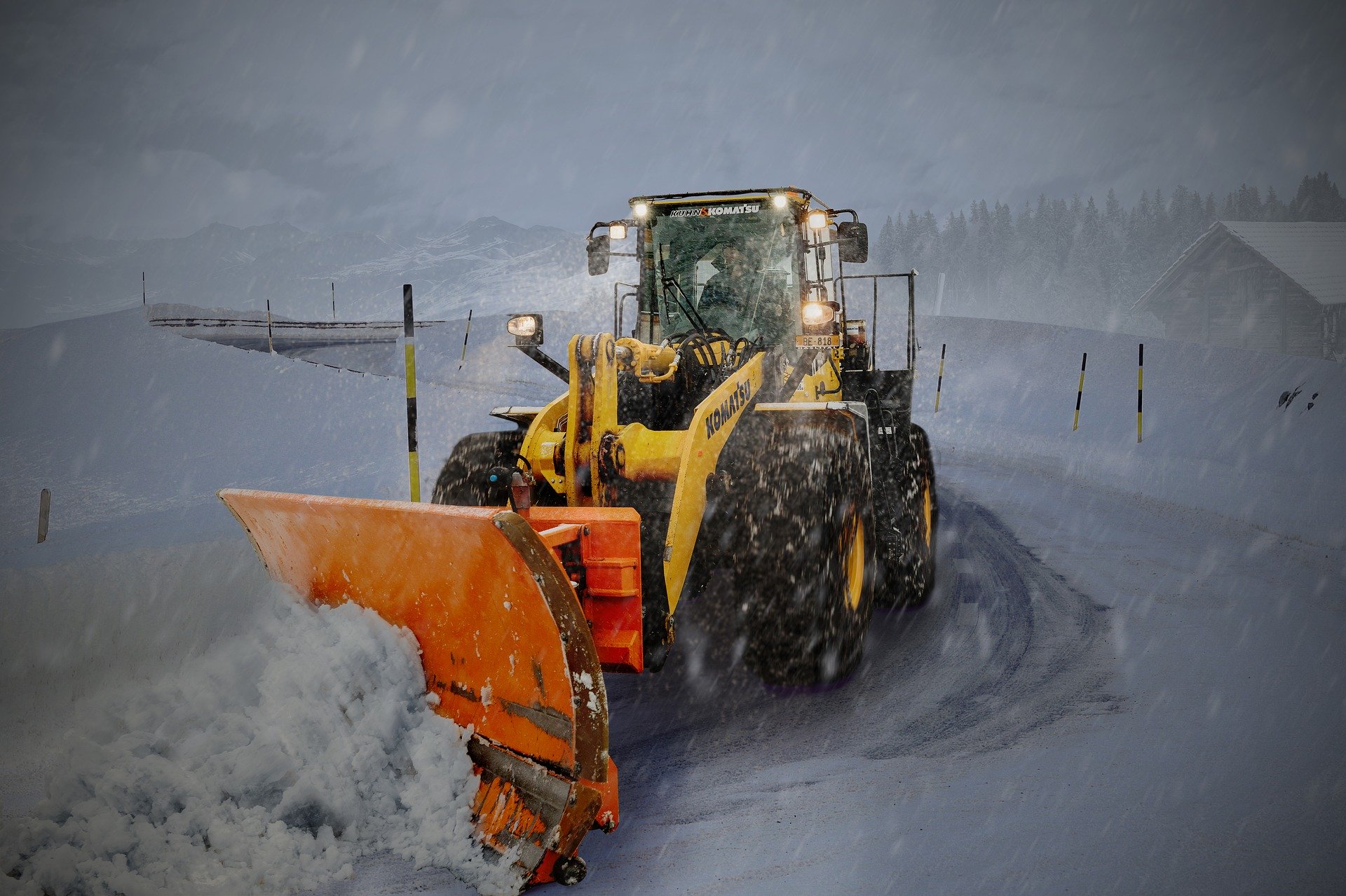 front loader plows snow