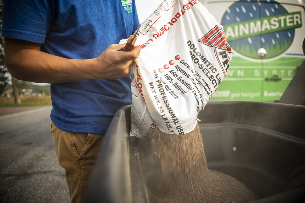 Adding lime to soil to increase the pH